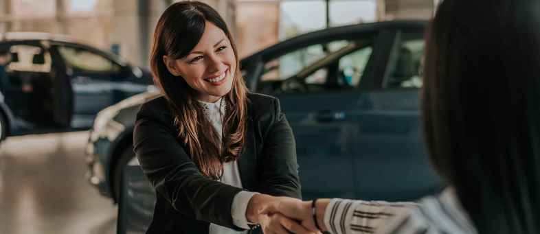 Women handle driver seat in car dealership.jpg Women handle driver seat in car dealership.jpg